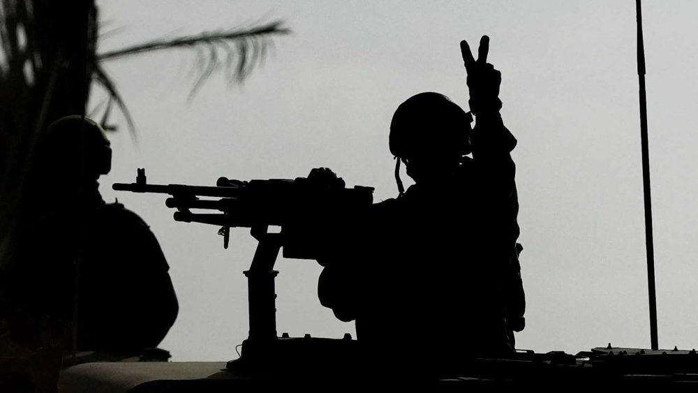 Israeli soldier flashes V for Victory sign as tanks roll into Gaza City to wipe out Hamas